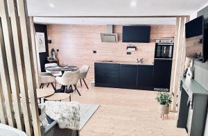 a kitchen with black cabinets and a table and chairs at 1 - 4 Pers Apartment Jeßnitz, Mawoi Living in Jeßnitz