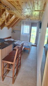 a kitchen and dining room with a table and chairs at Apartments Orchidea in Žabljak