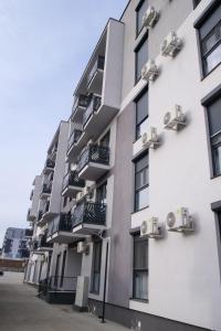 an apartment building with balconies on the side of it at Apartament Panorama Baile Felix in Baile Felix
