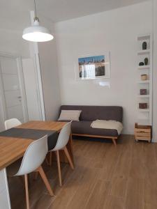 a living room with a table and a couch at Delicious in Francavilla al Mare