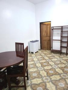 a dining room with a table and chairs and a floor at Delicious House, Watamu, 2-bedroom with secure compound free parking and wifi in Watamu