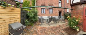 a patio with a table and chairs in front of a brick building at Fewo Rico 3 in Quedlinburg