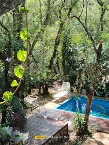 a backyard with a swimming pool and a wooden deck at Lo de Alicia in Candelaria