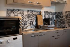 a kitchen with a sink and a counter top at Fisherman's House Cozy Duplex in Argenton-sur-Creuse