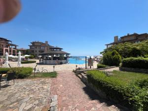 a cobblestone walkway with a gazebo and the ocean at Kaliakria Vibes studio apartment in Topola
