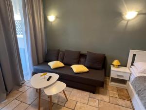 a living room with a couch and a table at Kaliakria Vibes studio apartment in Topola +34 photos