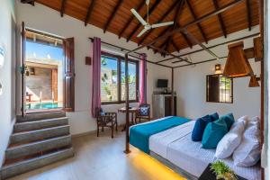 a bedroom with a bed in a room with a window at Anama by Queens Mount in Tangalle