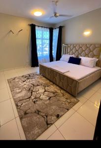 a bedroom with a large bed and a rug at Lulufurnishedapartments in Mombasa