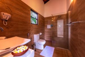 a bathroom with a shower and a toilet and a sink at Anama by Queens Mount in Tangalle +37 photos