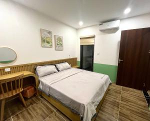 a small bedroom with a bed and a desk at Mon's house in Lạng Sơn +3 photos