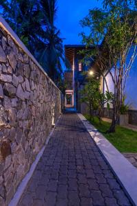a stone path leading to a house at night at Anama by Queens Mount in Tangalle