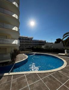 a swimming pool in front of a building at Cap Salou CALA FONT in Salou