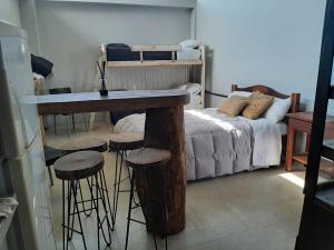 a room with a table and stools next to a bed at Ita Pora Lodge in Bella Vista +9 photos