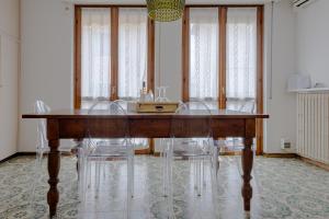a dining room with a wooden table and chairs at Boutique Apartment Cà Tulles in Torri del Benaco