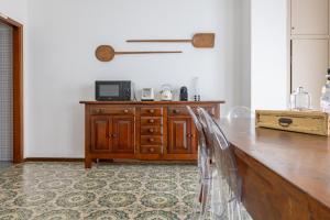 a kitchen with a wooden table and a counter top at Boutique Apartment Cà Tulles in Torri del Benaco +24 photos