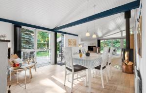 a dining room with a white table and chairs at Holiday Home Vestervænget Blåvand V in Ho