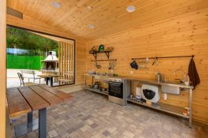 a wooden kitchen with a wooden table and a wooden wall at Montebelo Villas in Veliko Tŭrnovo +149 photos