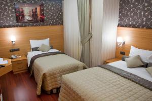 a hotel room with two beds in a room at Abel Hotel in Istanbul