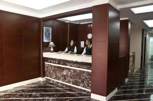 two people sitting at a counter in a hotel lobby at Abel Hotel in Istanbul