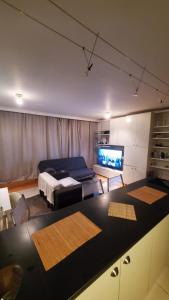 a living room with a bed and a television at Cavaye house in London