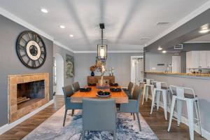 a dining room with a table and chairs and a fireplace at Luxury Heated Pool Spa Villa with Game Room & More! in Tampa