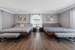 a room with two beds and a bench in it at Luxury Heated Pool Spa Villa with Game Room & More! in Tampa +83 photos