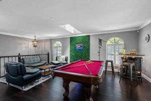 a living room with a pool table in it at Luxury Heated Pool Spa Villa with Game Room & More! in Tampa