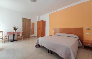 a bedroom with a bed and a table in it at Nice Apartment In Vieste With Wifi in Vieste