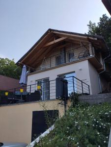 a house with a balcony on the side of it at Bovan vikendica izdavanje in Bovan