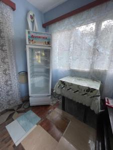 a kitchen with an empty refrigerator and a table at Casa familiala de vacanta in Bogdan Vodă +11 photos