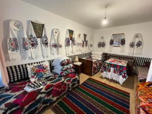 a living room with a couch and pillows on the wall at Casa familiala de vacanta in Bogdan Vodă