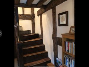 a staircase in a room with a book shelf at The Medlar in Kington