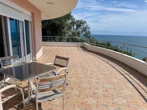 a patio with a table and chairs and the ocean at Nikić Apartments in Ulcinj