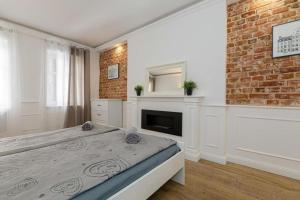 a bedroom with a bed and a brick wall at Urban Chic- Old Town - Great Location - Uniwersytecka in Wrocław +15 photos