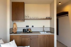 a kitchen with wooden cabinets and a sink at RiZEΣ in Ouranoupoli