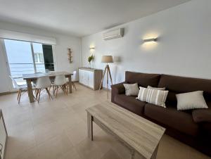 a living room with a couch and a table at Casa Pueblo Ciutadella in Ciutadella