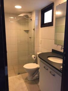 a bathroom with a toilet and a sink at Duplex no Centrinho de Pipa cozinha e 2 banheiros in Pipa +40 photos
