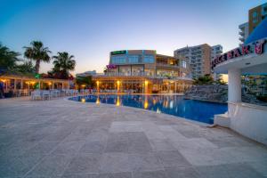 a hotel with a pool in front of a building at Caesar Resort & SPA - Studio Apartment - Amelius in Iskele +15 photos