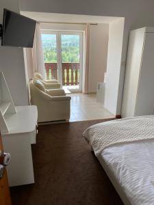 Ένα ή περισσότερα κρεβάτια σε δωμάτιο στο Ostoja