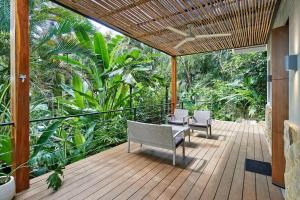 - une terrasse couverte avec 2 chaises et une table dans l'établissement Tucán Studio Malpais, à Malpaís