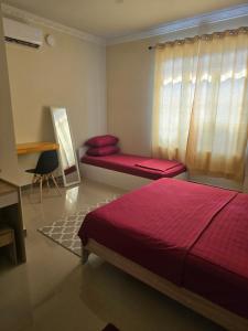 Postel nebo postele na pokoji v ubytování Maagali Inn + 7 fotografií