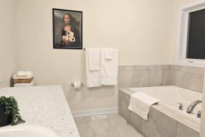 a white bathroom with a tub and a sink at 5beds 2800 sqft house, sleeps 11, 18 mins to falls in Thorold +52 photos