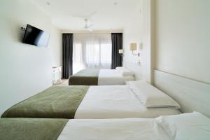 Postel nebo postele na pokoji v ubytování Hostal Sol y Miel