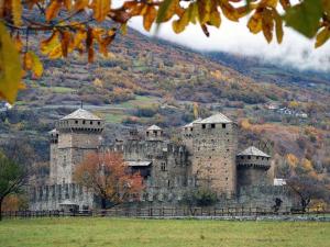 an old castle sitting on top of a hill at Casa Vacanze Chez Sapin in Fenis