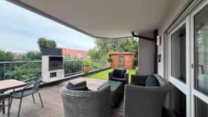 a patio with chairs and a table on a balcony at LudwigsHome Luxus - Zentral, Kostenloser Parkplatz, Terrasse in Ludwigsburg