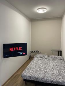 a bedroom with a bed and a television on the wall at Apartment Ferrari track in Fiorano Modenese +7 photos