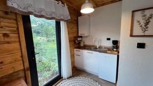 a kitchen with a large window in a room at Hanging Garden Holiday Home - Riverside in Ardeşen +40 photos