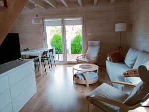 a living room with a couch and a table at Domki letniskowe Czapli9 Domki Rewal Apartamenty in Rewal