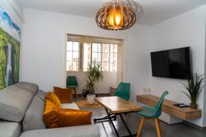 a living room with a couch and a table at Céntrico y luminoso in Huelva