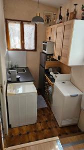 a small kitchen with a sink and a stove at Petite maison avec terrasse in Bezons
